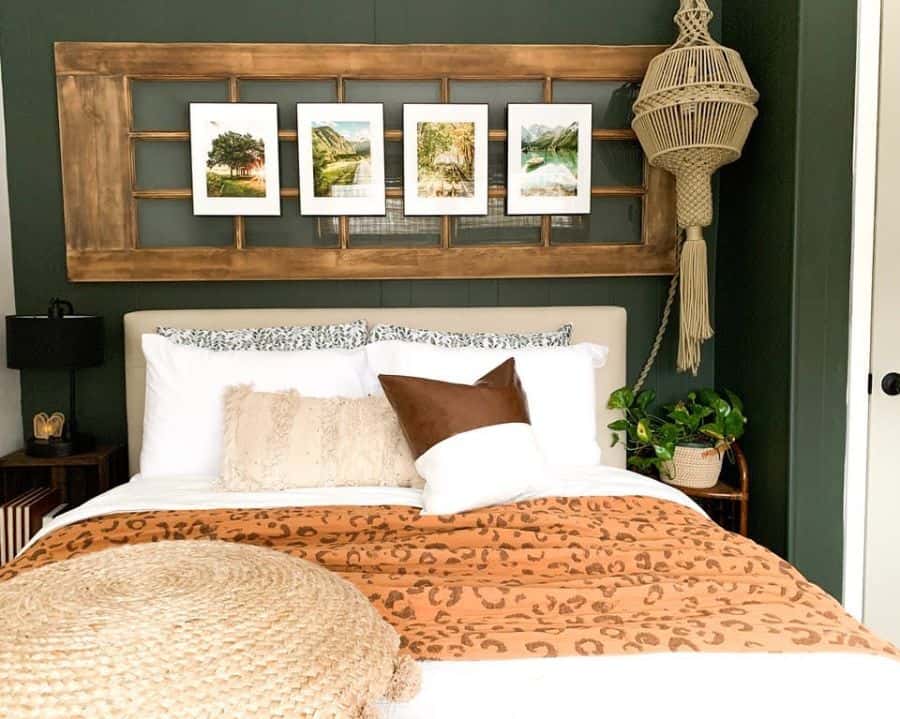 Boho bedroom with green accent wall, rustic photo frame decor, macrame lighting, and animal print bedding.