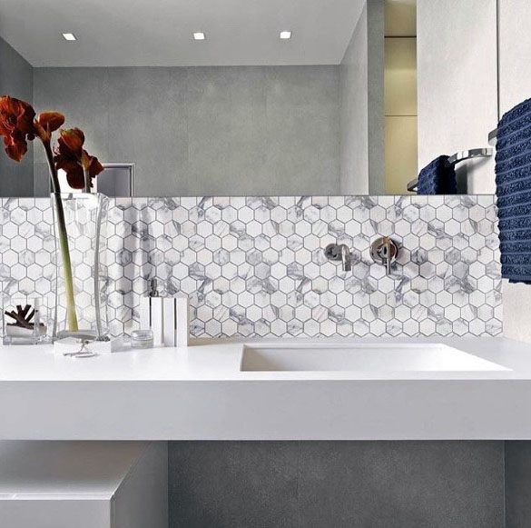 White marble hexagon tile backsplash with minimalist countertop and modern faucet.