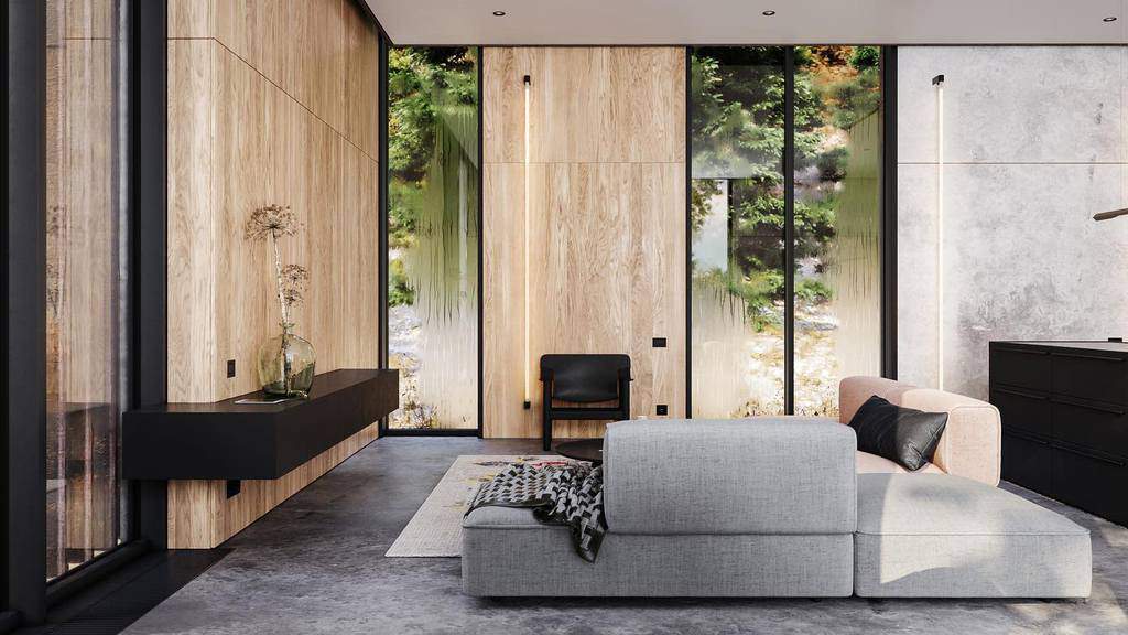 Modern minimalist living room with natural wood panel walls, a sleek gray sectional sofa, and large glass windows overlooking a lush green outdoor setting