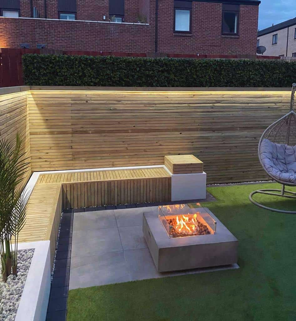 small corner backyard with wood bench and fire pit