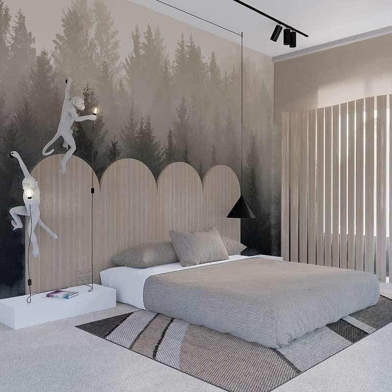 Modern bedroom with forest mural, monkey wall lights, and a neutral platform bed.