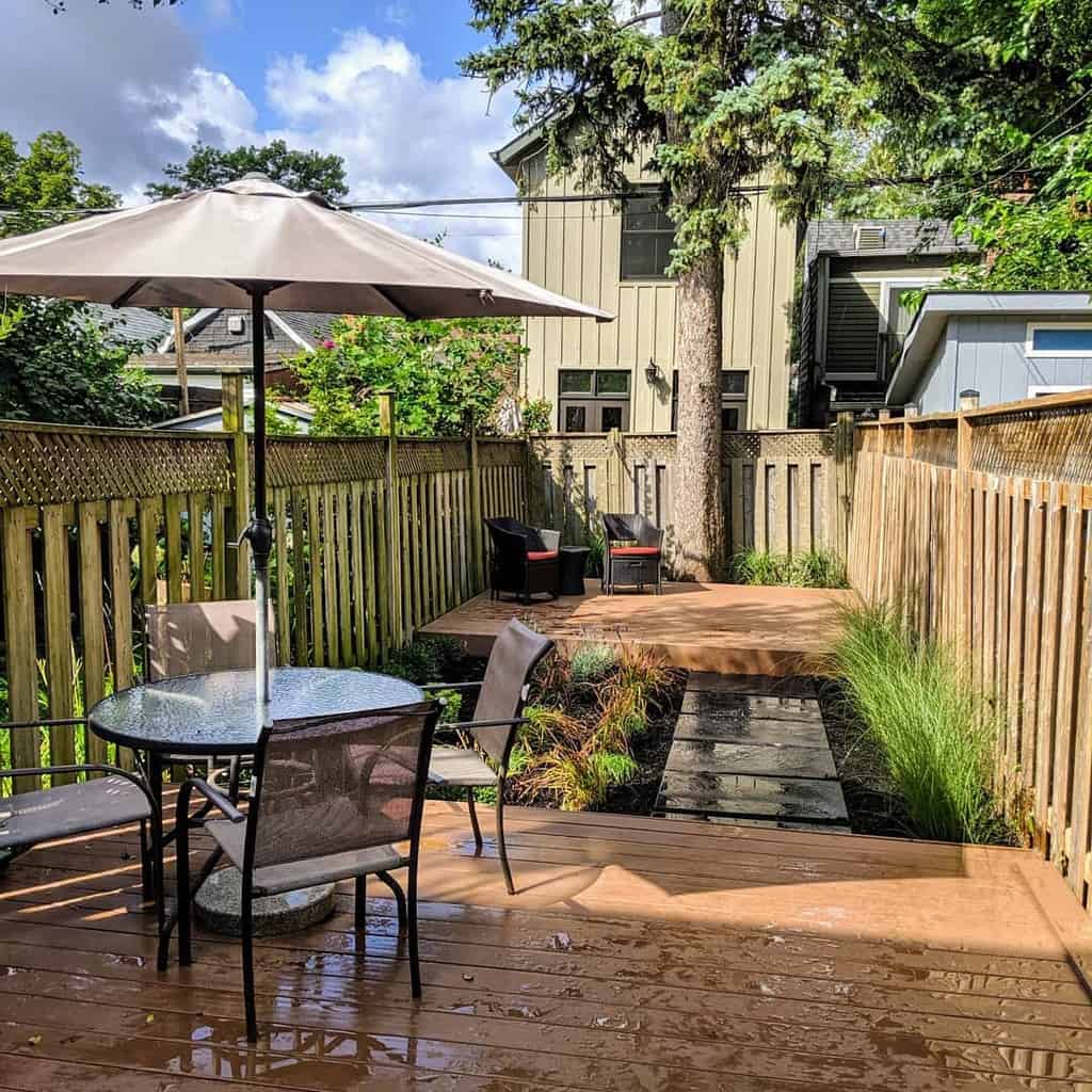 small narrow backyard with decks and outdoor furniture 