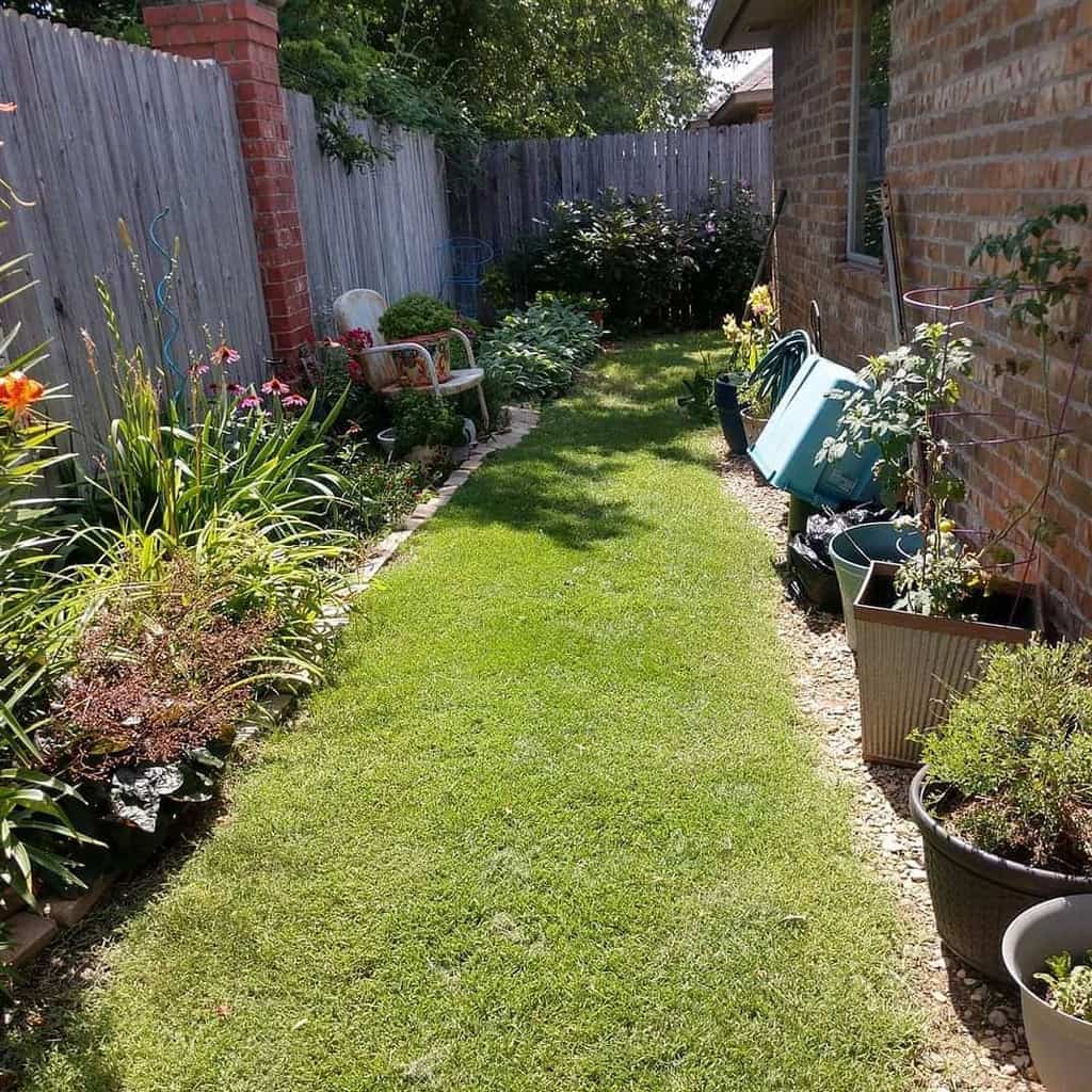 narrow side yard with grass and fence garden