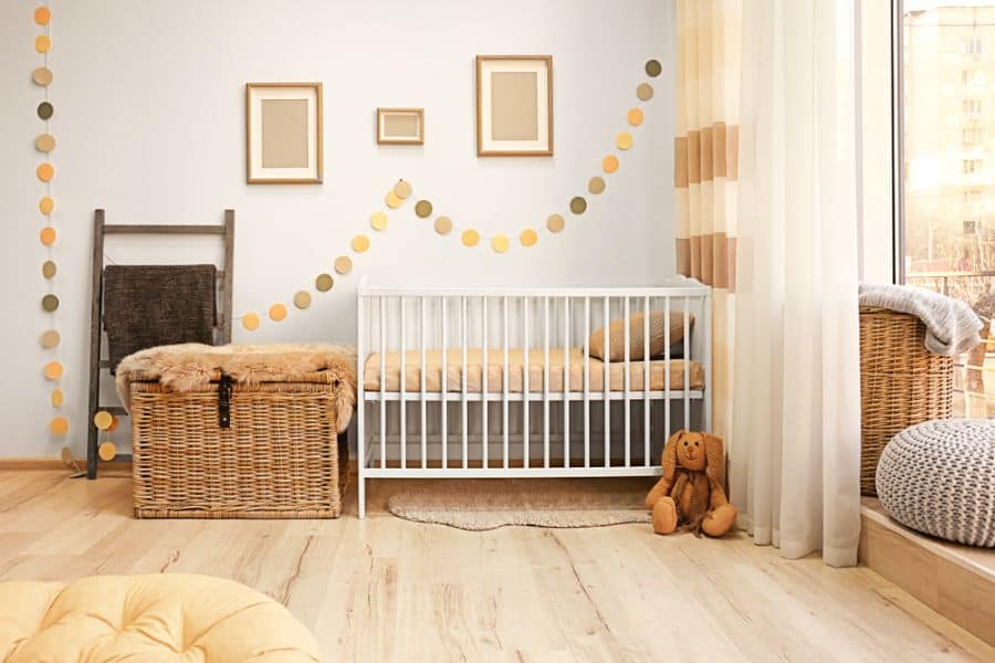 Baby room with earthy tones, wicker storage baskets, and white crib accented by yellow decor elements.