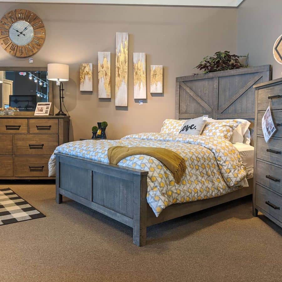 Rustic bedroom with wood furniture, patterned bedding, and large wall clock.