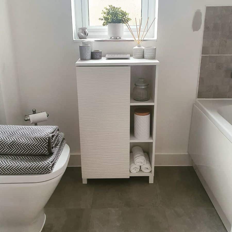 simple neutral color bathroom textured vanity towels on toilet 