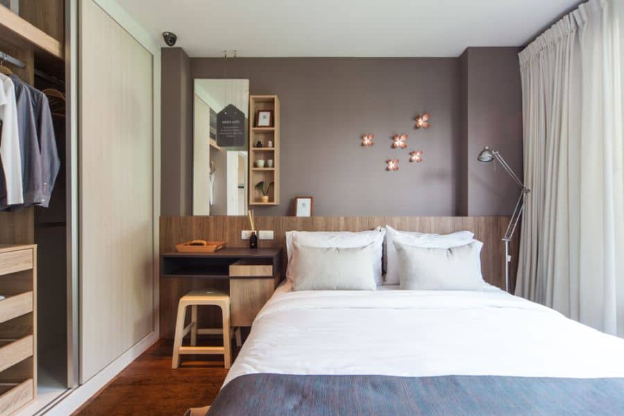 gray accent wall in small master bedroom with built-in wardrobe 