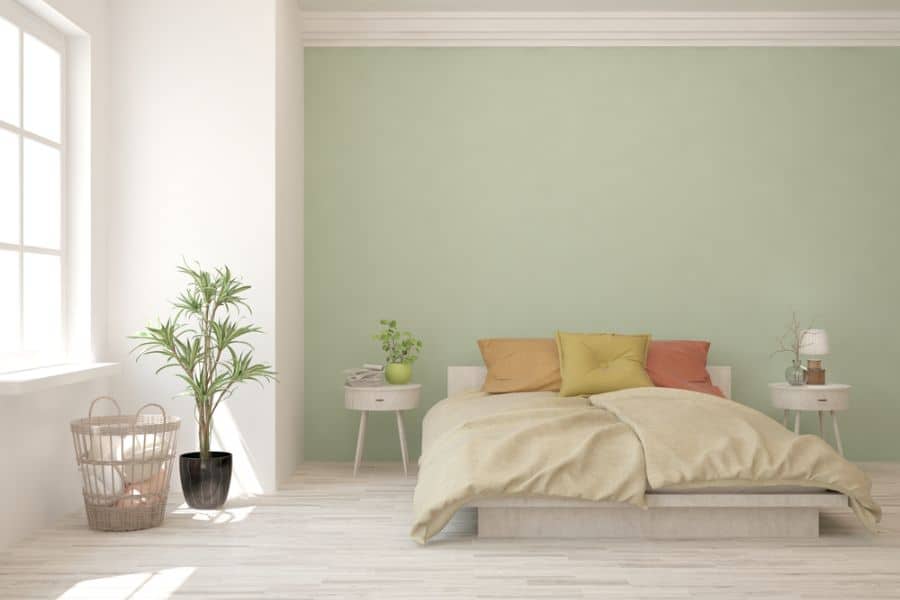 Large pastel green bedroom with platform bed and minimal decor.