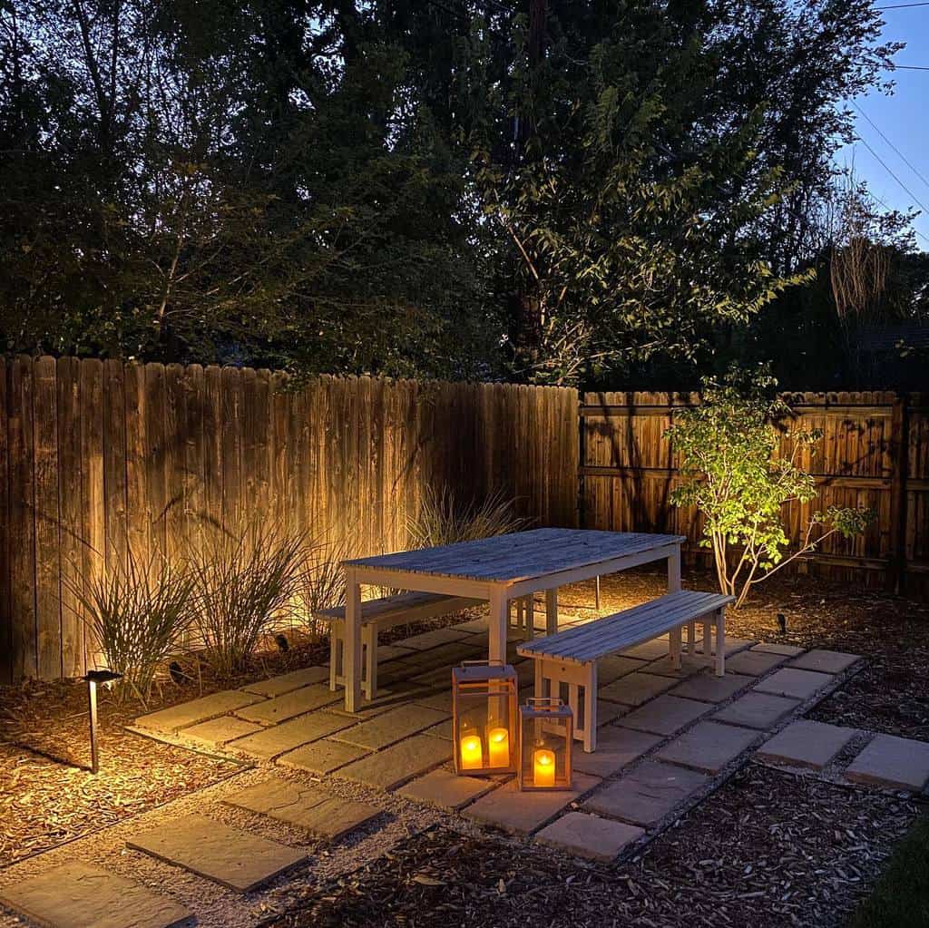 small paver patio wood table and benches floor candles 