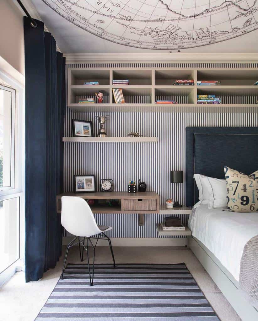 Bedroom with striped wallpaper, atlas ceiling art, mounted shelves, and patterned floor rug.