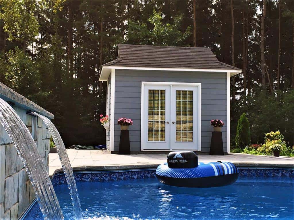 backyard pool fountain pool shed potted plants 