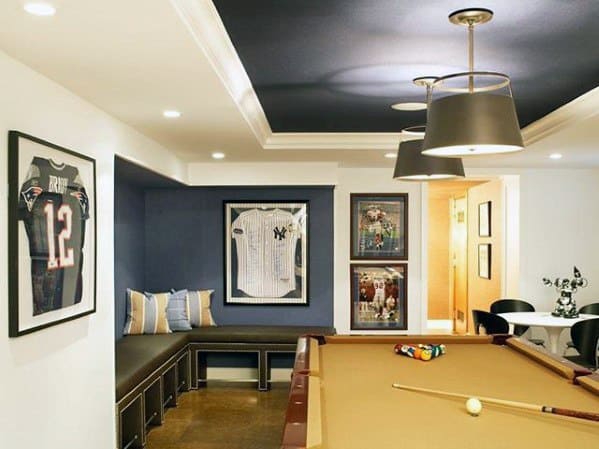 Baseball-themed mancave with bat display, shelves of shoes and helmets, and modern seating area.