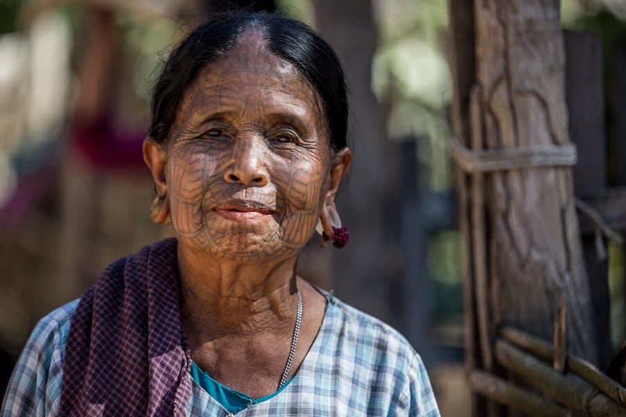 portrait of old woman with facial tattoos 