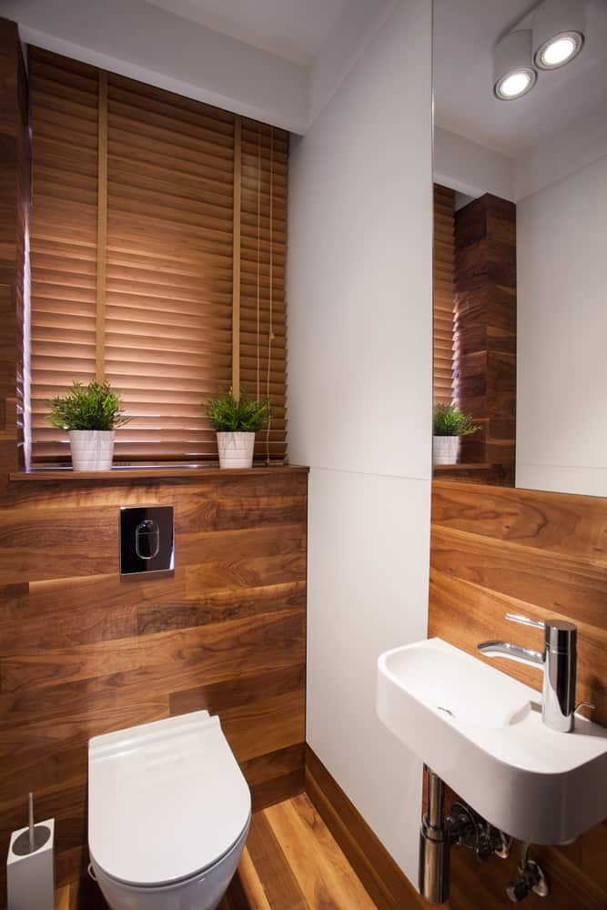 small powder room with wood accents 