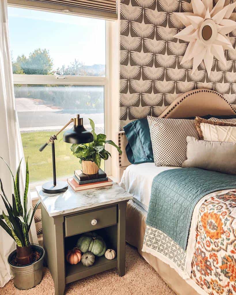 Bedroom with printed wallpaper, green nightstand, potted plants, and teal bedding.