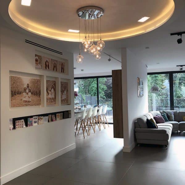 open living space kitchen with family photos on hallway wall