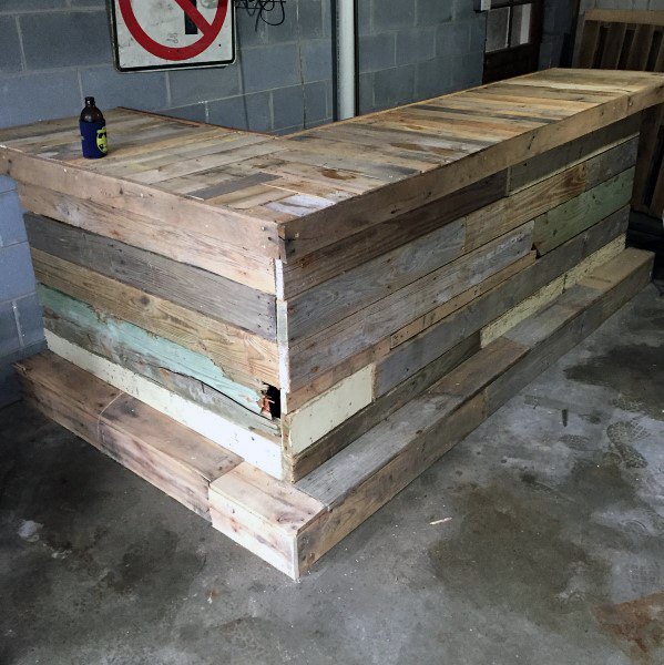 Rustic garage bar made from reclaimed wood with a natural, unfinished look and sturdy design.