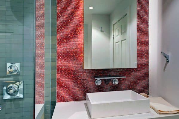 Bathroom with red mosaic tile backsplash, square vessel sink, and wall-mounted faucet.