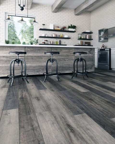 Rustic kitchen featuring wide-plank wood flooring, a weathered wood island, industrial stools, and open shelving.