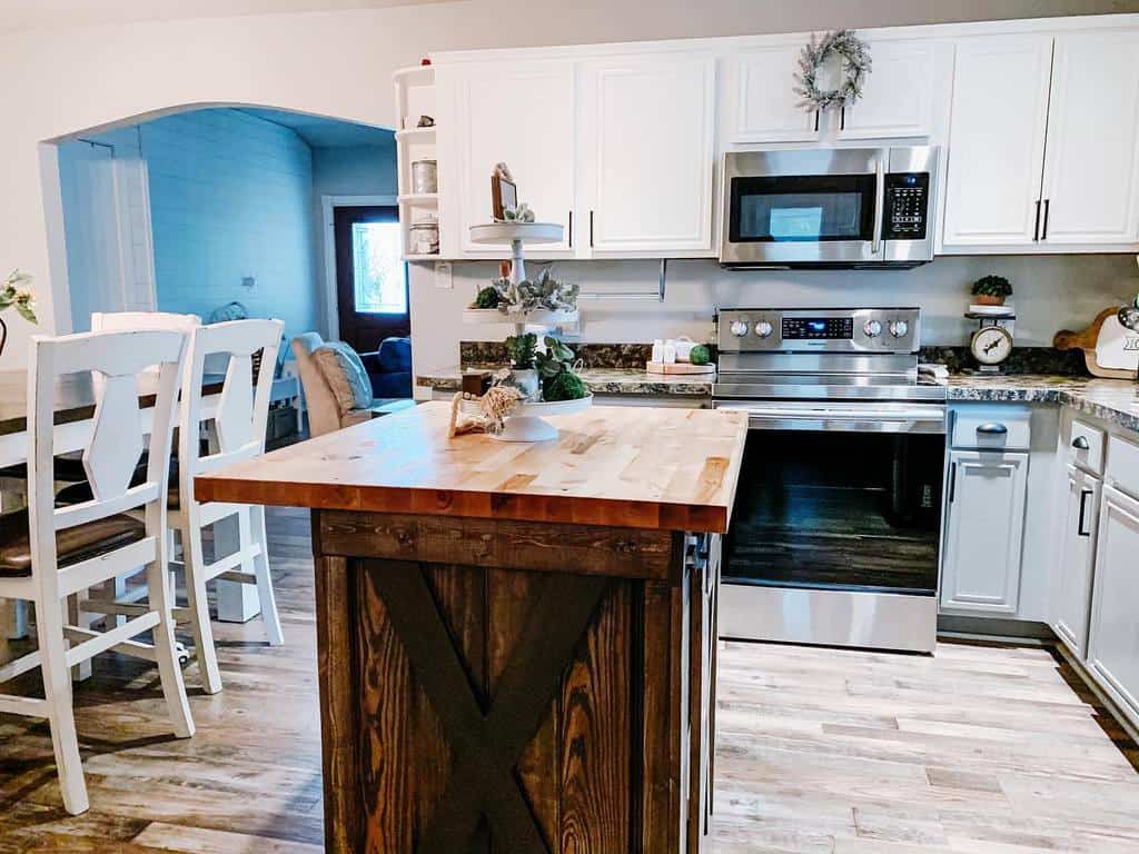 light airy kitchen white cabinets wood island dining room 