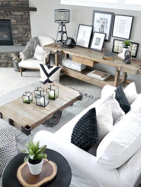 A rustic luxe living room with a stone fireplace, vintage-style furniture, wooden accents, and stylish decor, creating a cozy yet elegant atmosphere