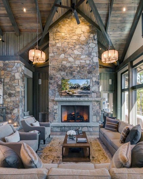 living room with stone wall and high ceiling 