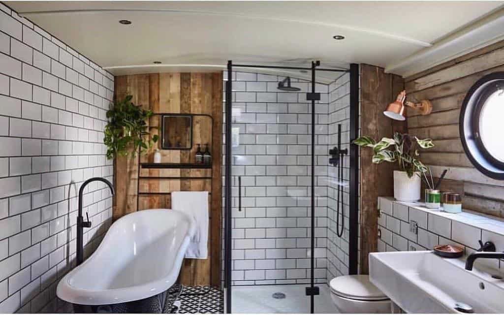 luxury boat bathroom with white tiles wood accents and freestanding tub 