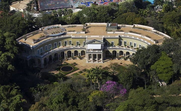 Safra Mansion in Brazil, a grand semicircular estate surrounded by lush greenery and gardens.