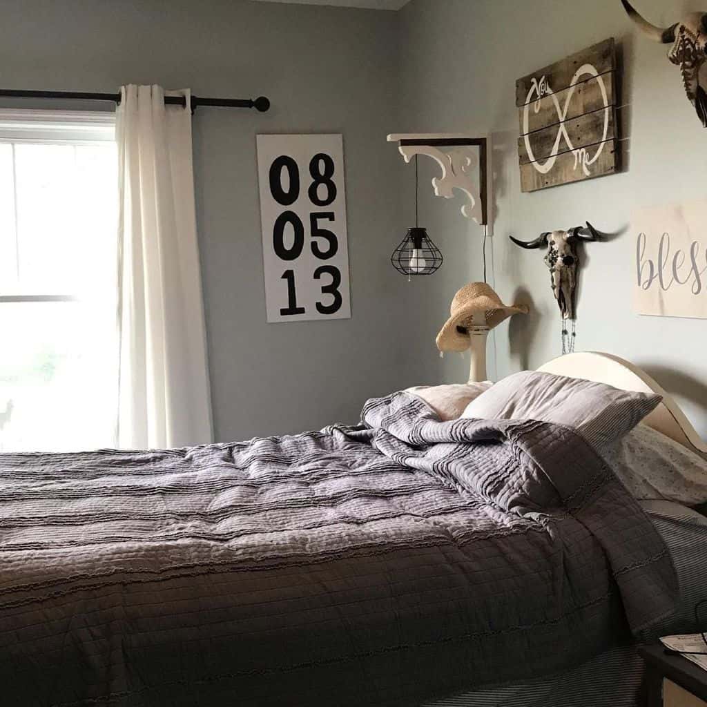 Rustic bedroom with farmhouse decor, skull wall art, and cozy gray bedding.