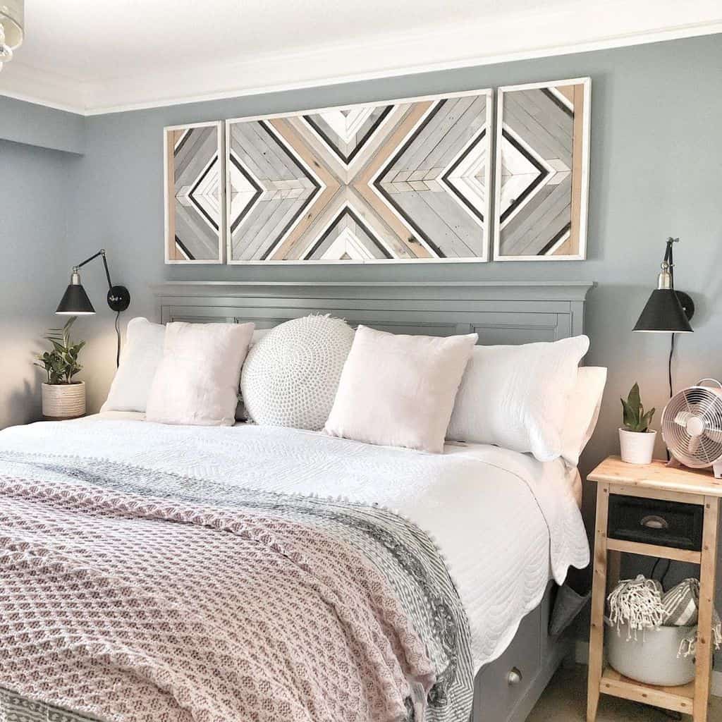 Country-style bedroom with geometric wall art, cozy bedding, and bedside plants.