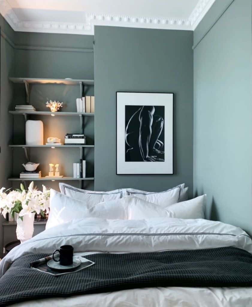 Green bedroom featuring built-in shelving and framed wall art for a cozy and modern aesthetic.