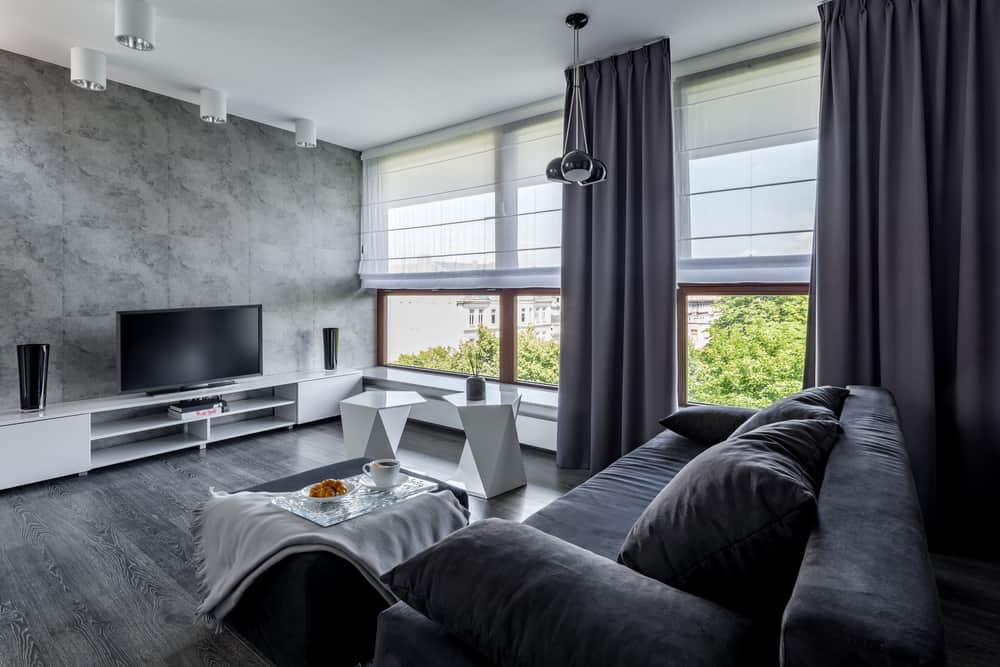 gray living room with sofa white shade and thick curtains 