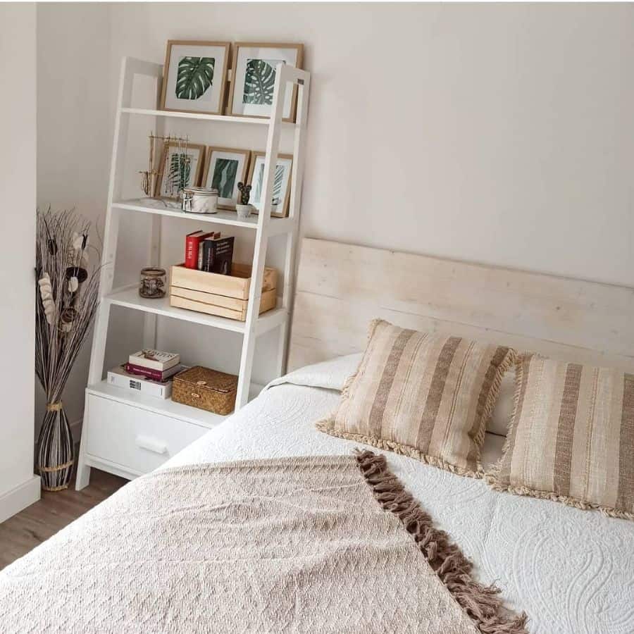 Cozy bedroom with white storage shelf, natural decor, and beige accents.