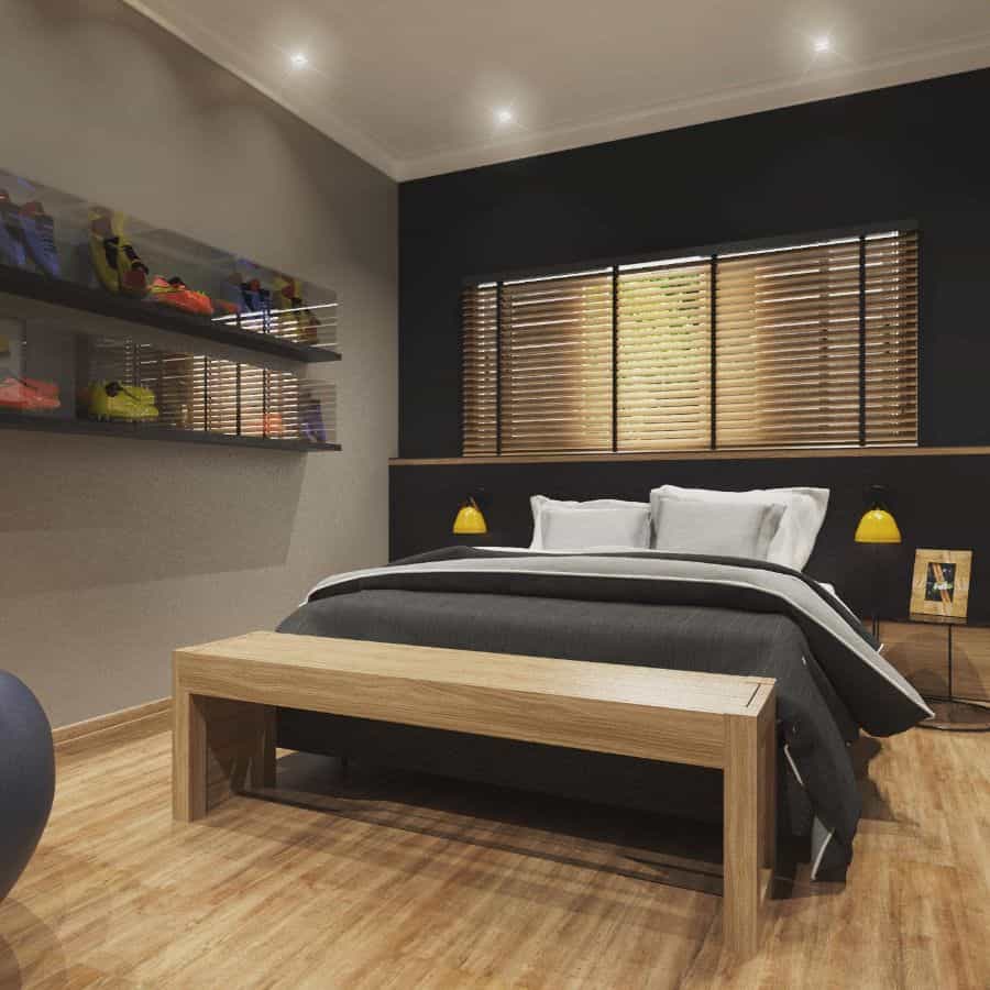 Modern bedroom with wall shelves displaying football boots, wooden bench, and yellow lamps.