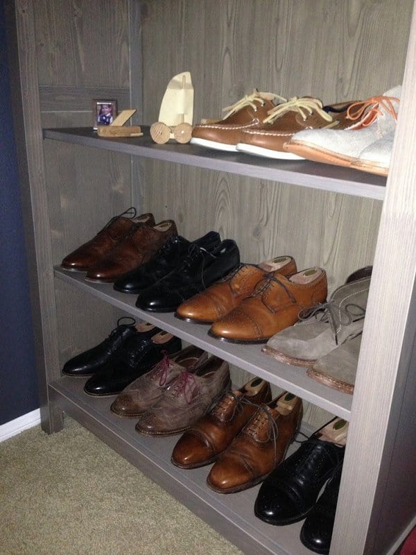 Wooden shoe shelf neatly organizing leather dress shoes and casual footwear, creating a clean and elegant storage solution