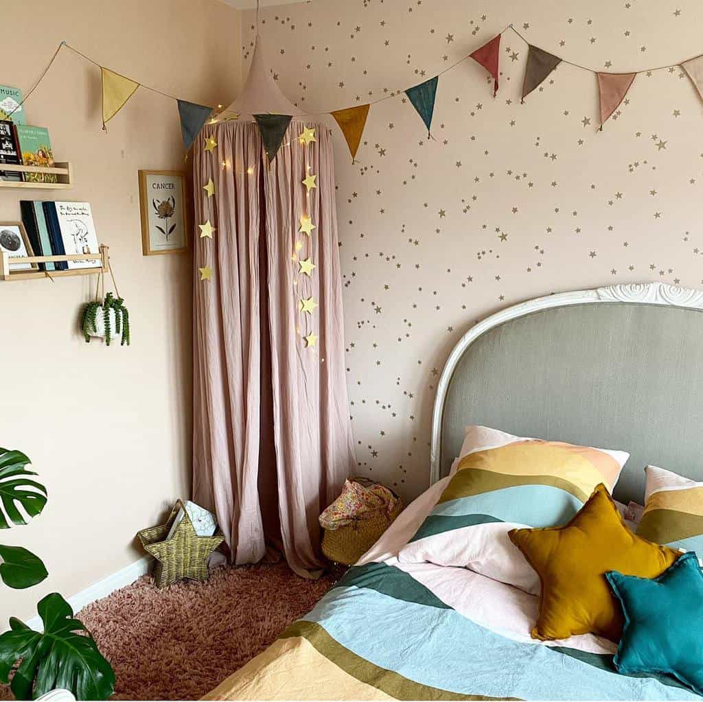 Kids' room with star-patterned wallpaper, pink canopy, colorful bedding, and wall shelf decor.