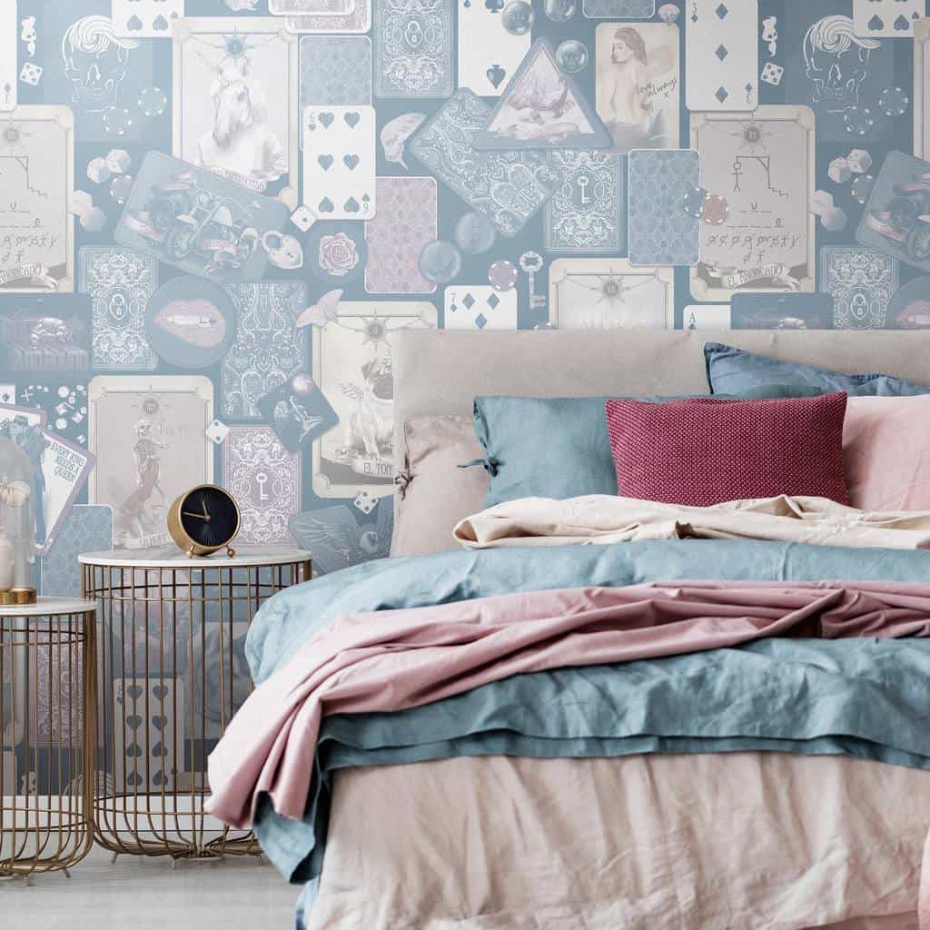 Bedroom with modern card-themed wallpaper, pastel bedding, and gold accent bedside tables.