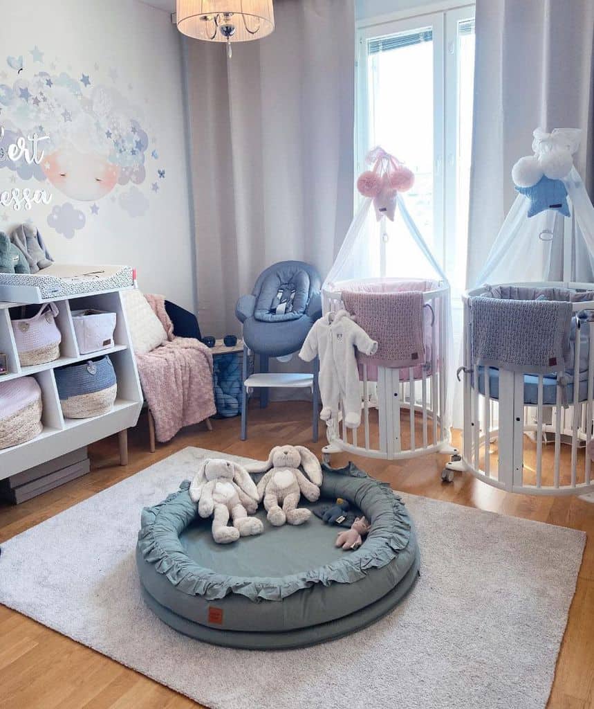 Simple his and her baby room with twin cribs, soft toys, and pastel decor accents.