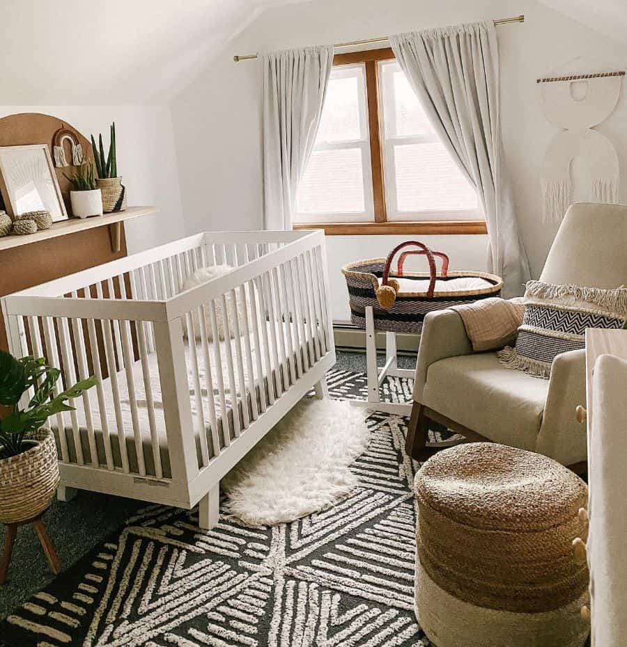 Cozy nursery with white crib, woven bassinet, textured rug, and barn-style decor accents.