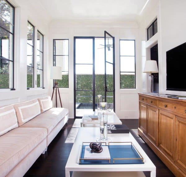 Sunroom with dark hardwood floors, modern decor, and natural light.