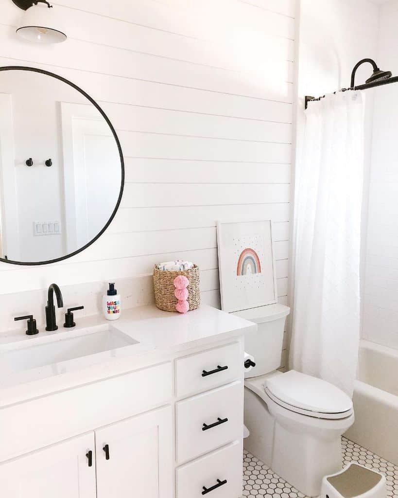 white shiplap wall bathroom white vanity black accents tile floor 