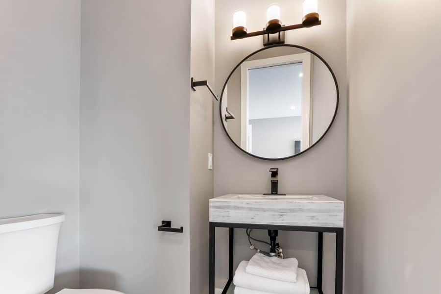 elegant small powder room with black accents 