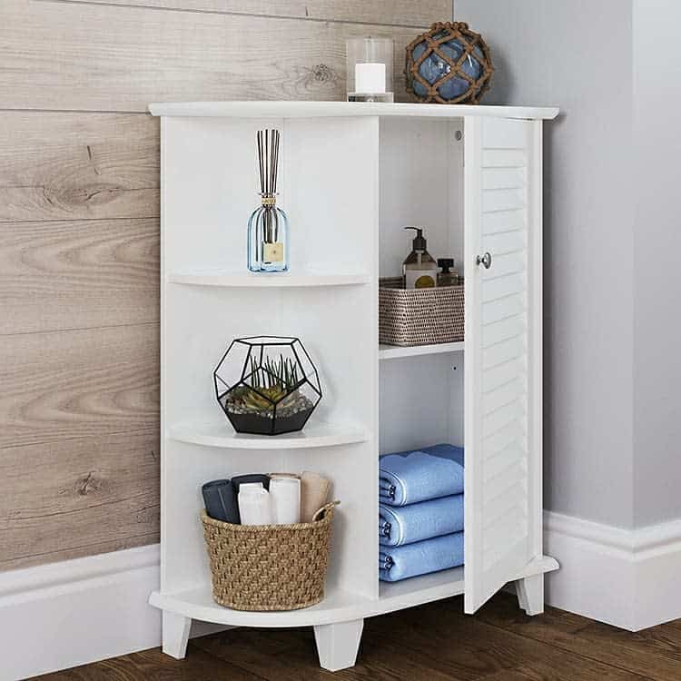 White freestanding bathroom cabinet with open shelves and wicker basket for storage.