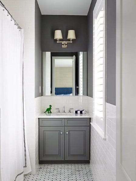 Small bathroom with grey vanity, white subway tiles, and mosaic tile floor.