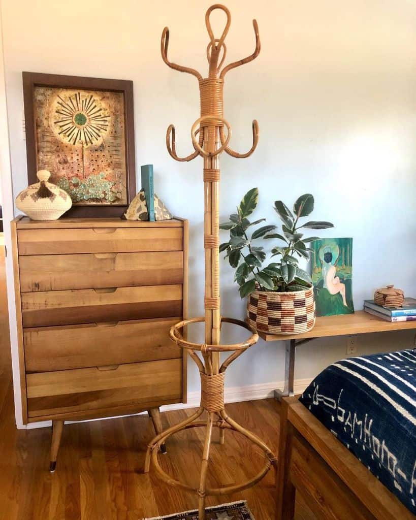 small vintage bedroom with cane coat hanger and wood cabinet 