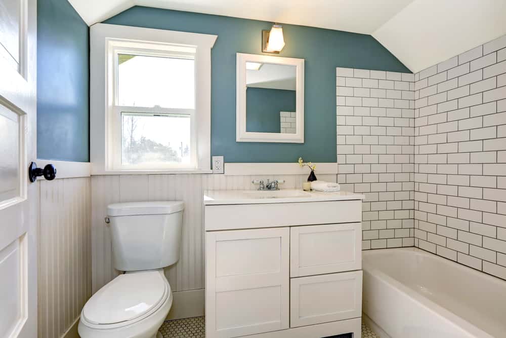 farmhouse bathroom with white tiles and green walls