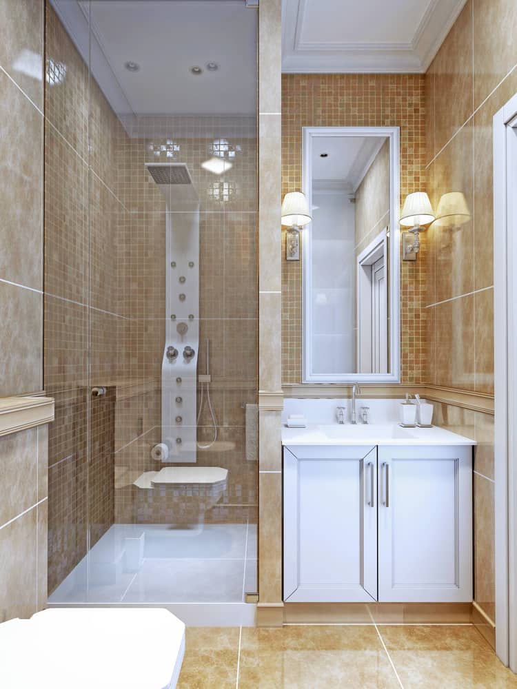 Contemporary bathroom with beige tiles, glass shower enclosure, and modern white vanity.