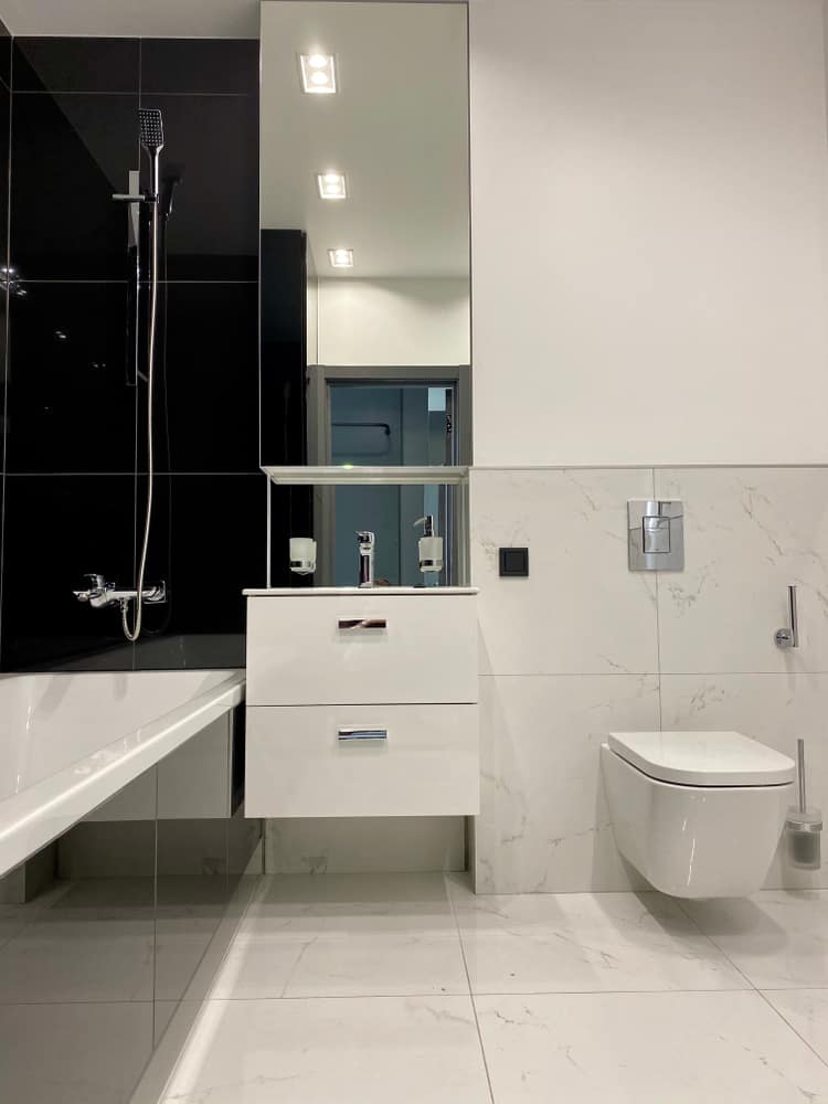 modern small bathroom with black tile accents 