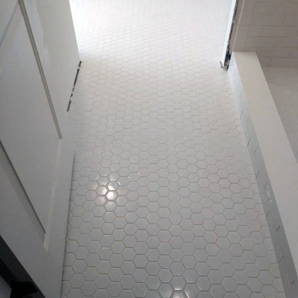 Bathroom with white hexagonal honeycomb floor tiles and minimalist design.