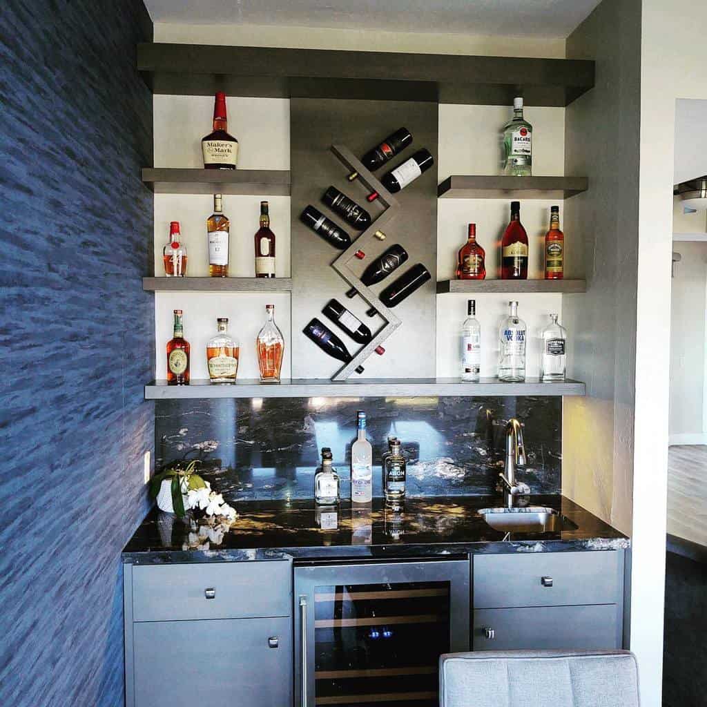 Modern wet bar with a sleek black marble countertop, floating shelves, and a geometric wine rack for a stylish, contemporary look.